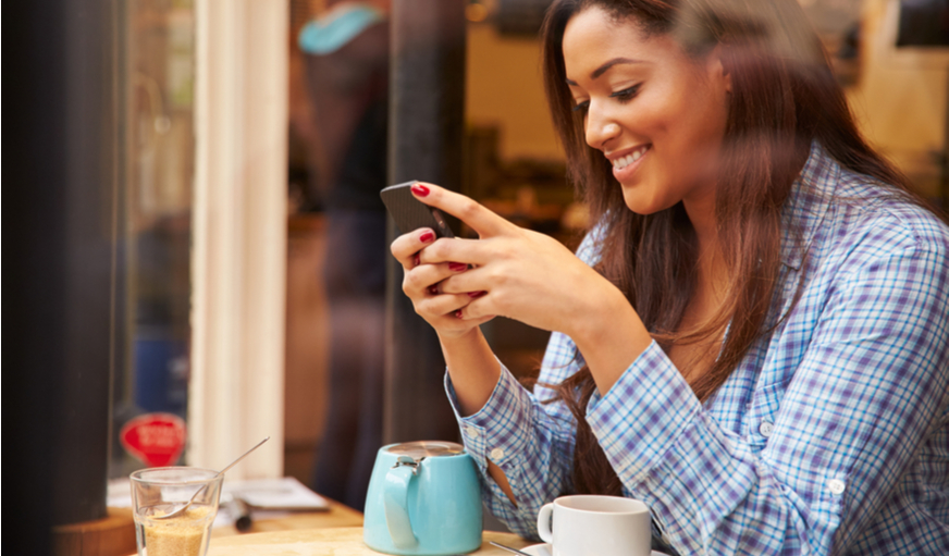 Woman on her phone in a coffee shop