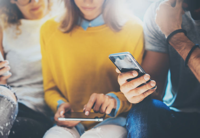 groupe de jeunes vérifiant leur téléphone