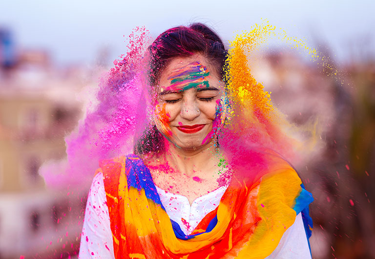 Woman with colourful paint smudges on her face
