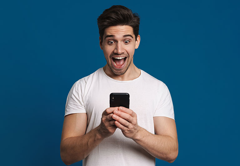 man happy looking at phone